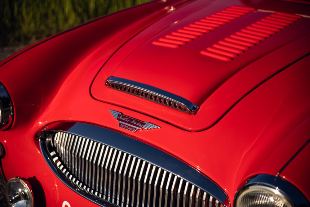 Close-up of red vintage Austin-Healey 3000 sports car.