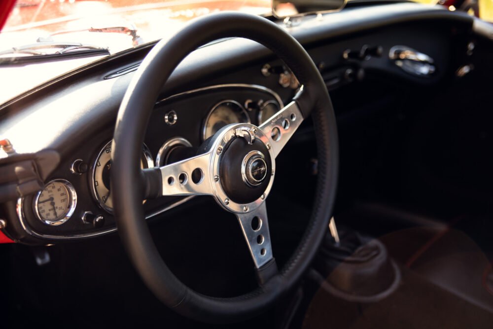 Vintage car dashboard and steering wheel.