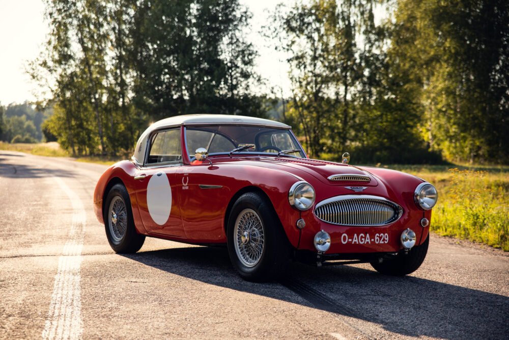 Vintage red sports car on a sunny road.