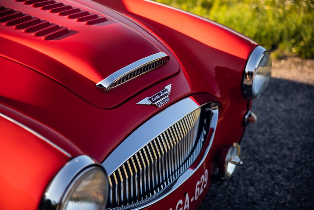 Close-up of red Austin-Healey 3000 MKIII hood and grille.