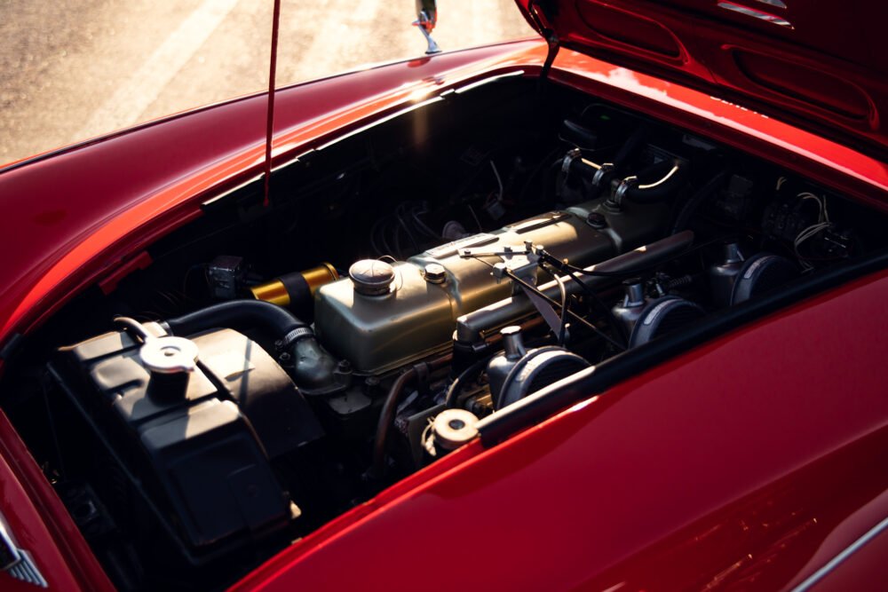 Vintage red car engine detailed view.