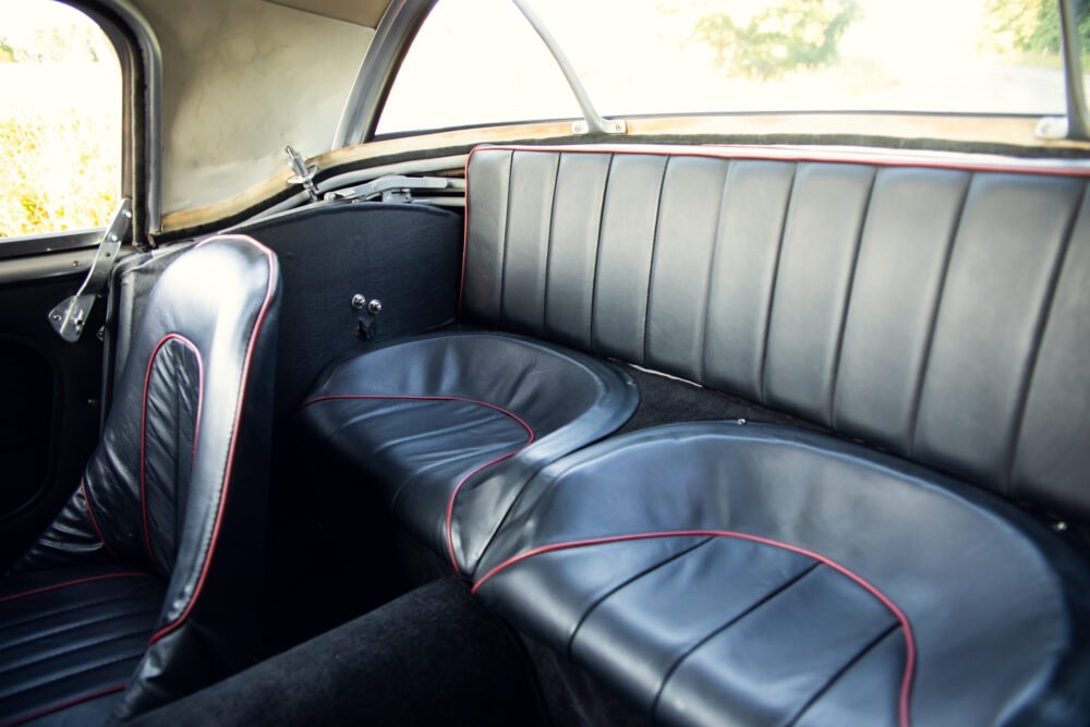 Vintage car interior with black leather seats.