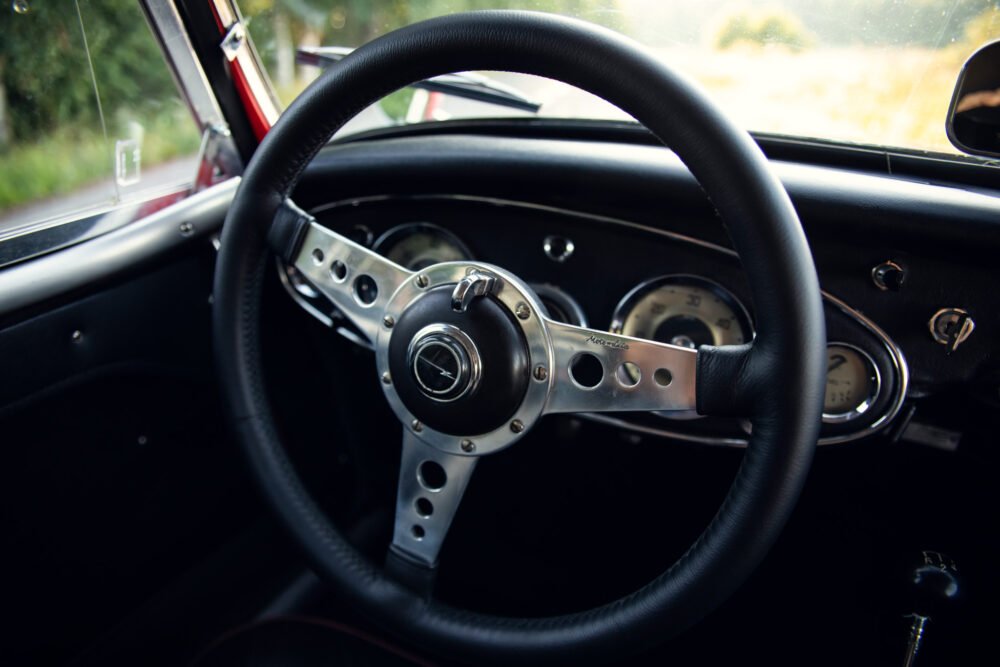 Vintage car steering wheel and dashboard interior.