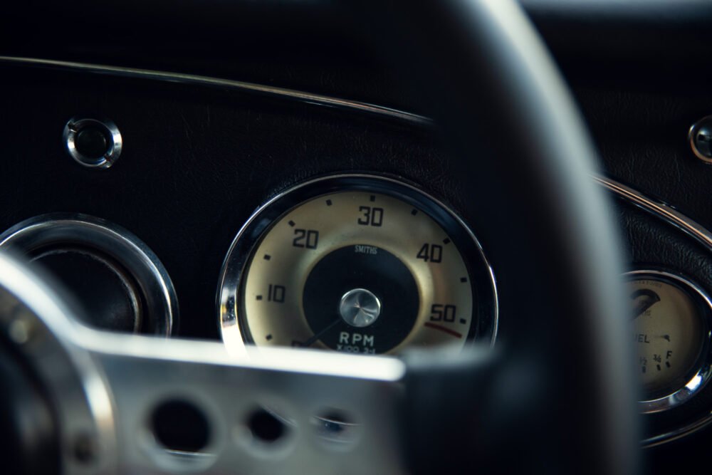 Vintage car dashboard with classic Smiths tachometer.