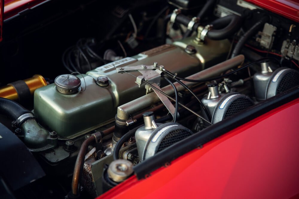 Vintage car engine close-up with detailed components.