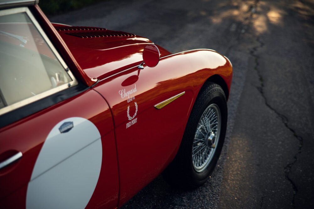 Vintage red sports car with racing decals.