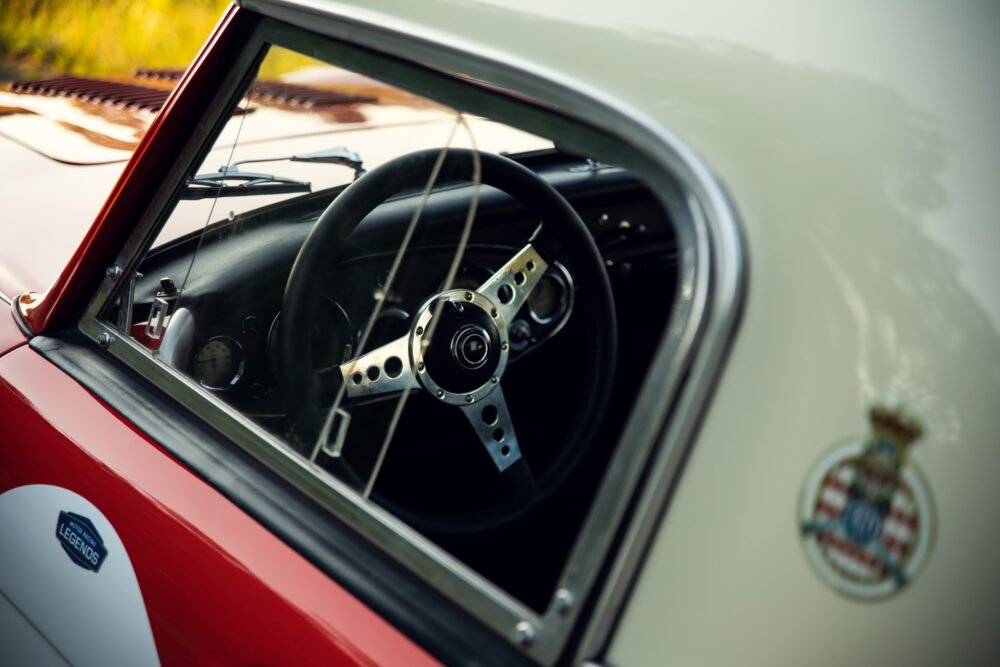 Vintage sports car interior, steering wheel close-up.