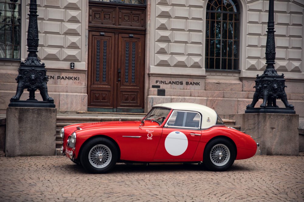 Vintage red sports car in front of Finland's Bank.