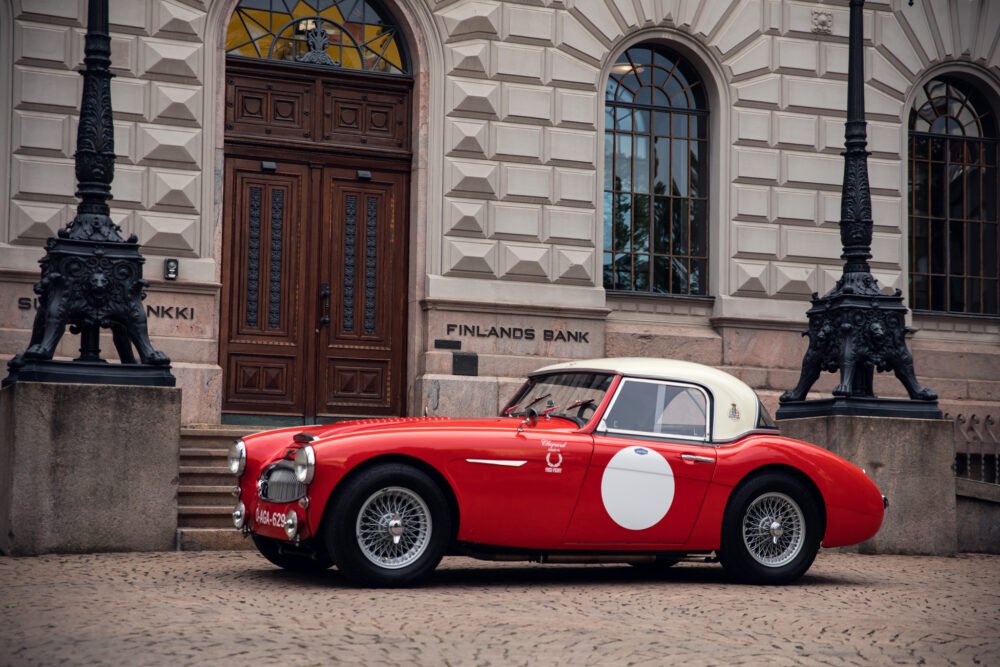 Vintage red car parked outside Bank of Finland.