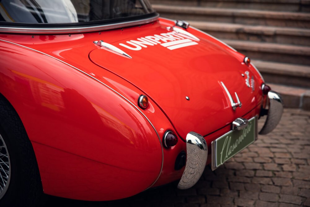 Red vintage sports car with chrome details.