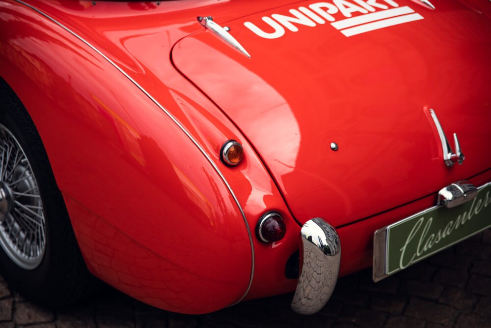 Close-up of red vintage sports car rear detailing.