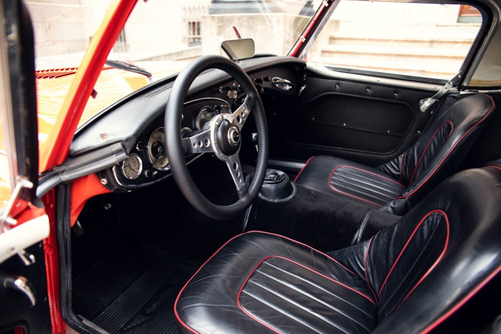 Vintage car interior with black and red seats.