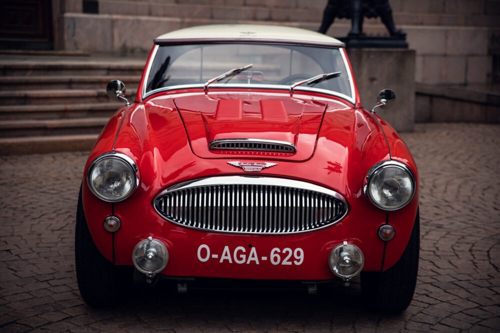 Vintage red Austin Healey sports car, license O-AGA-629.