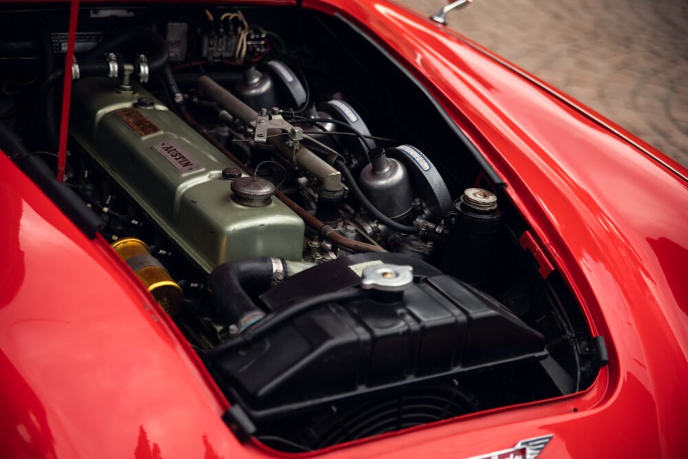 Vintage red car engine detailed close-up.