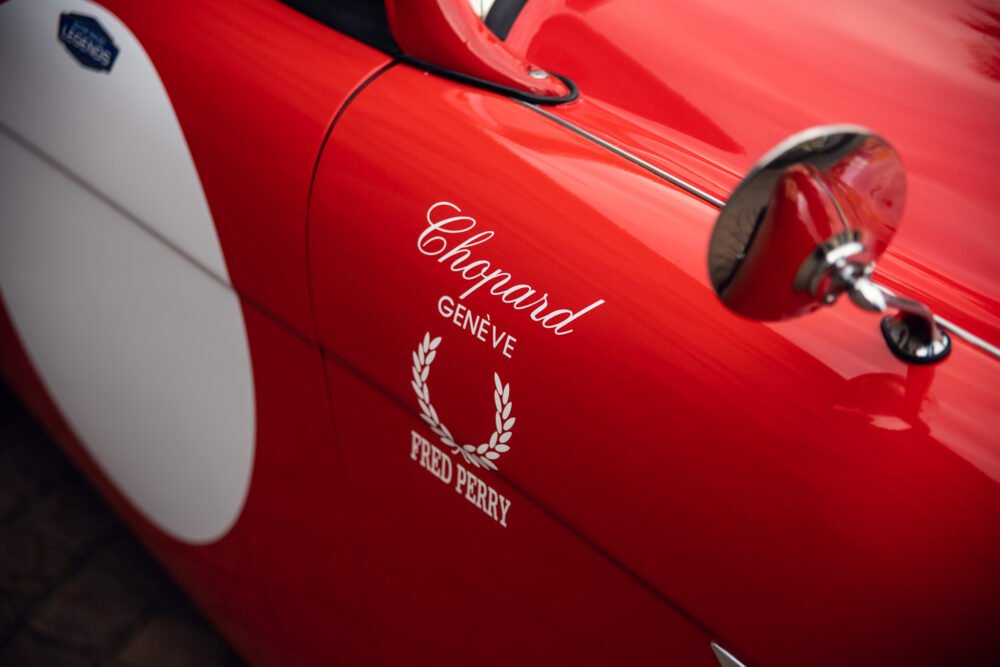 Red vintage car with Chopard and Fred Perry logos.