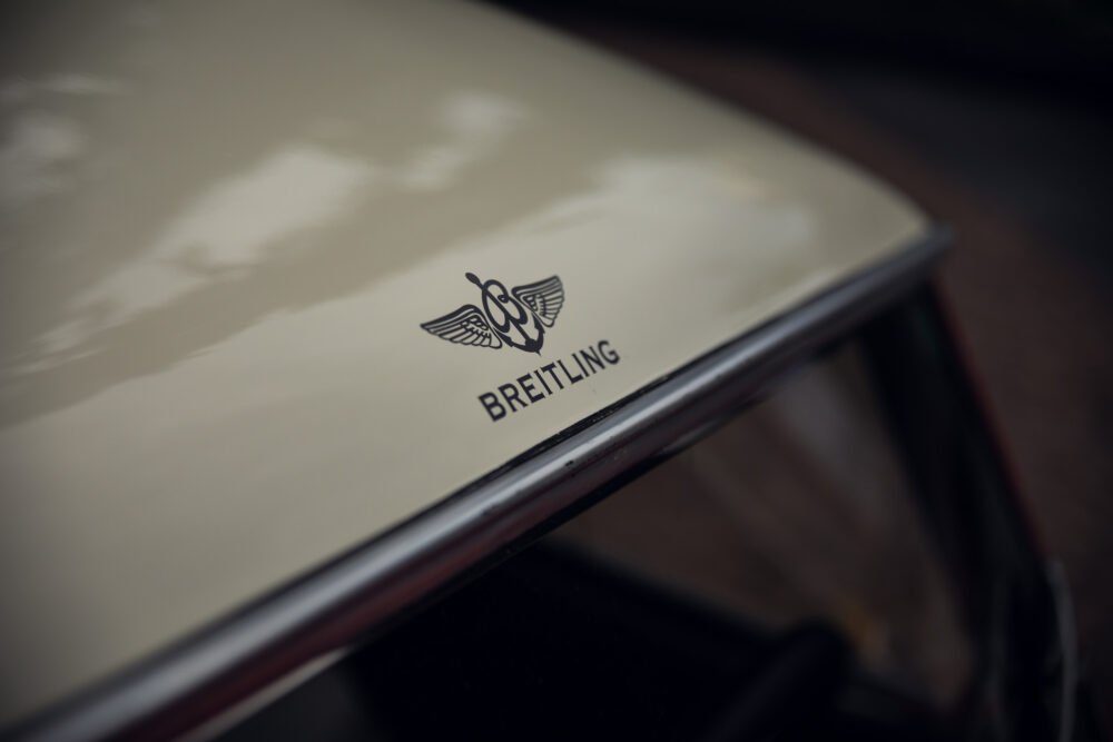 Breitling logo on a beige car hood.