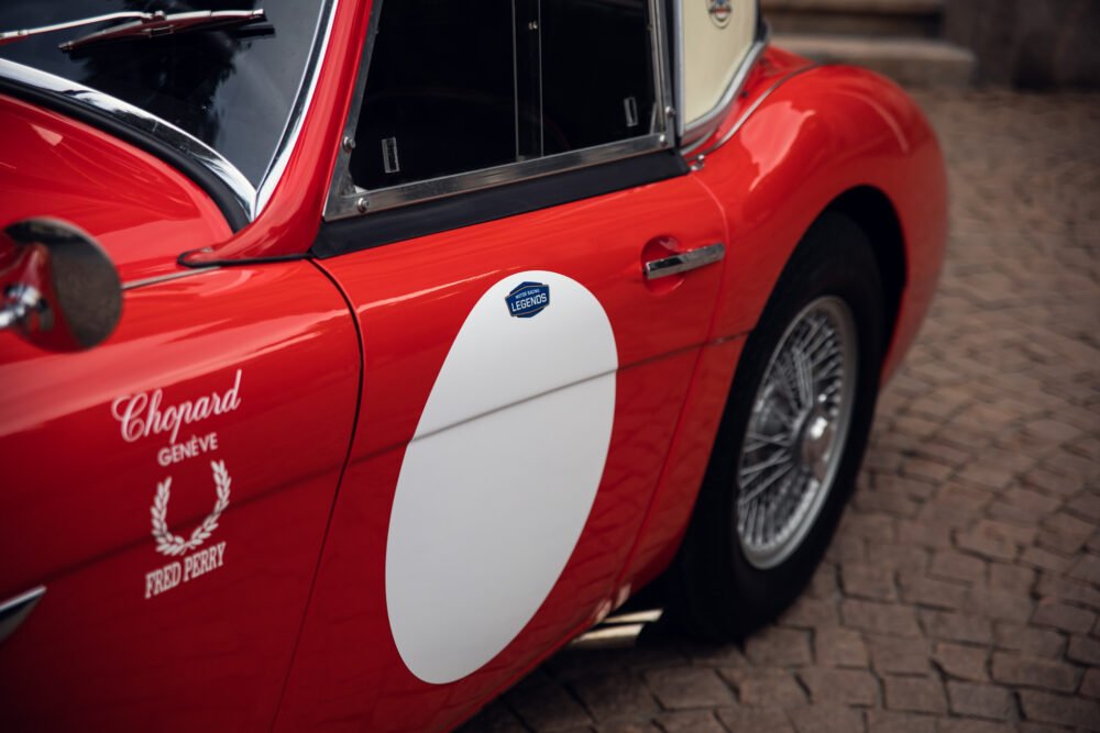 Red vintage sports car with stylish white racing stripe.