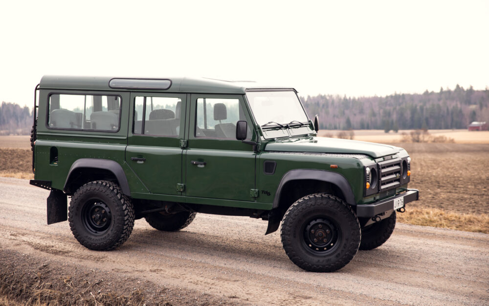 Green off-road vehicle on rural dirt road
