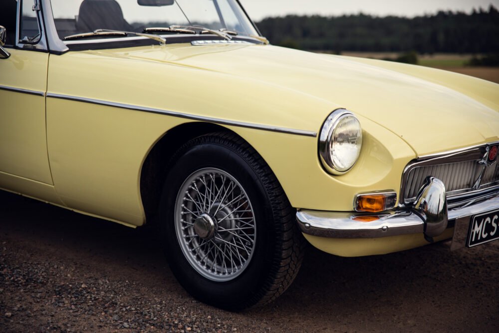 Yellow vintage MG convertible car close-up.