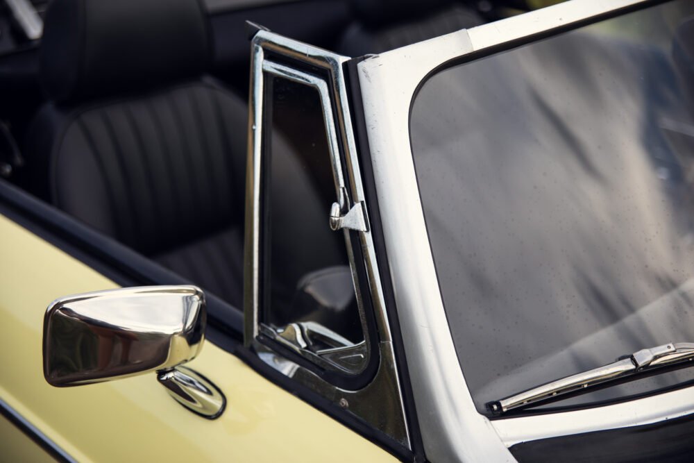 Vintage car door and mirror detail.