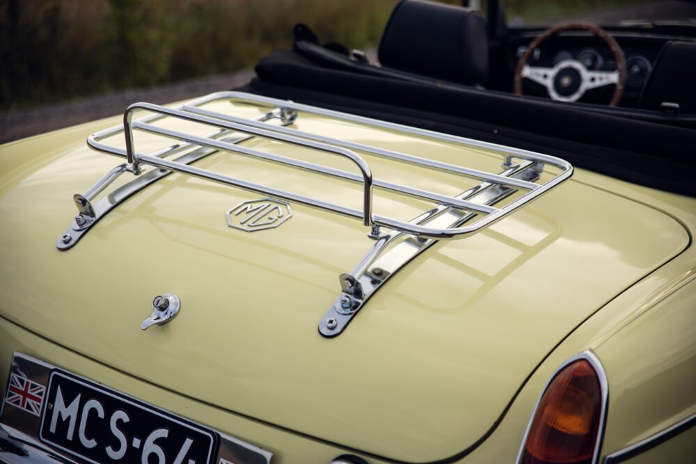 Vintage MG convertible with chrome luggage rack.