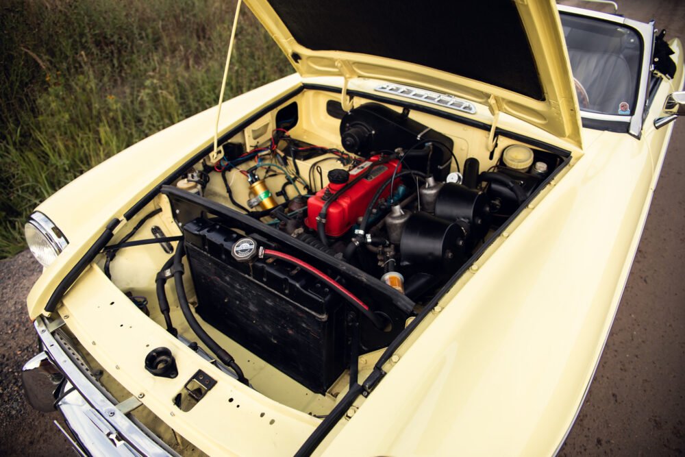 Yellow vintage car engine open display.