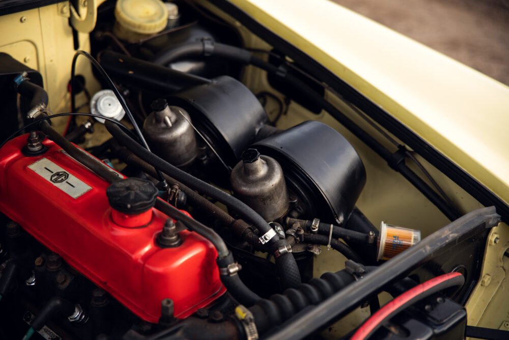 Vintage car engine close-up with red cover.