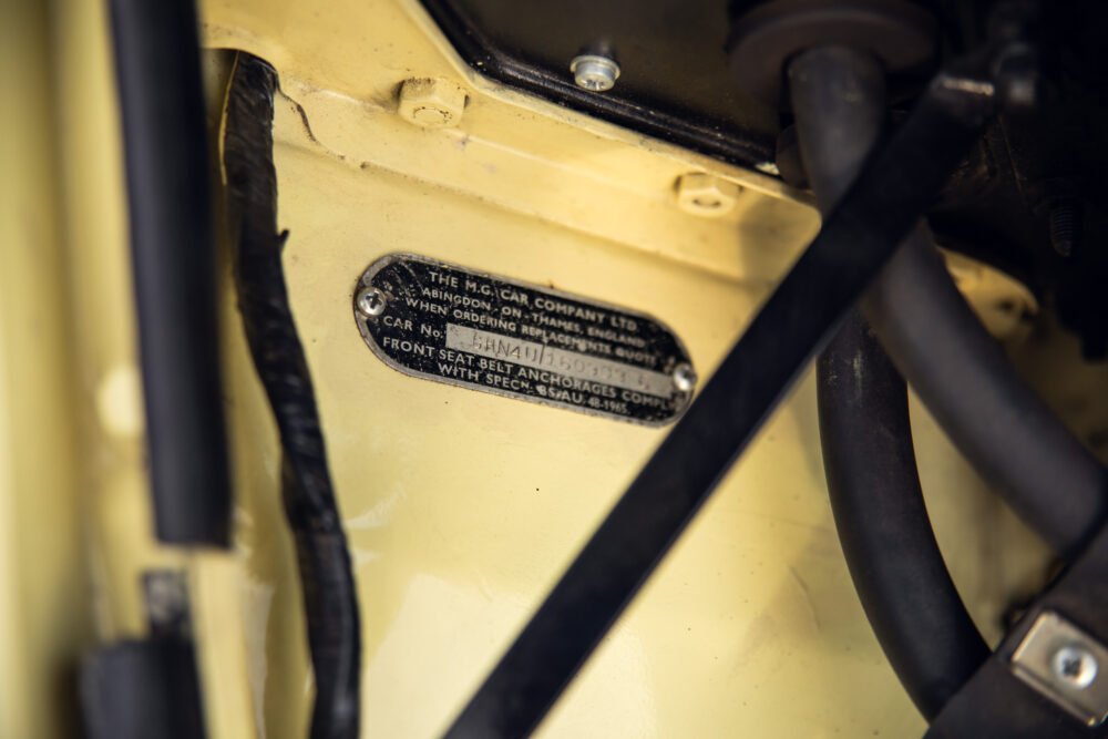 Close-up of vintage car's identification plate and details.