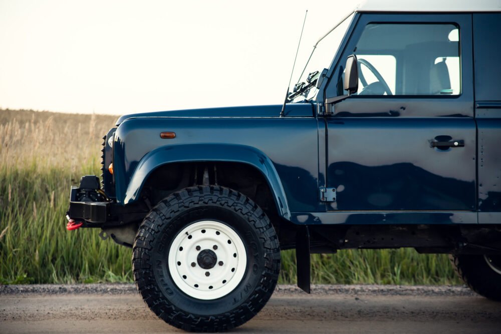 Blue off-road vehicle on rural road.