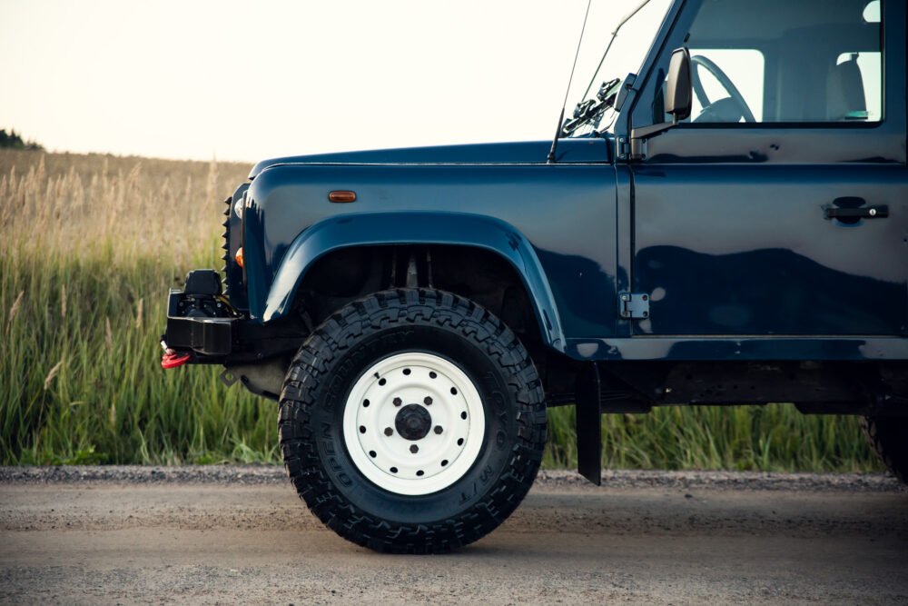 Blue off-road vehicle on a rural road.