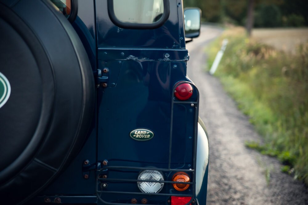 Close-up of Land Rover's rear side on road.