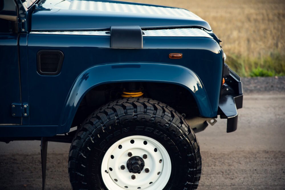 Close-up of blue off-road vehicle's front side.