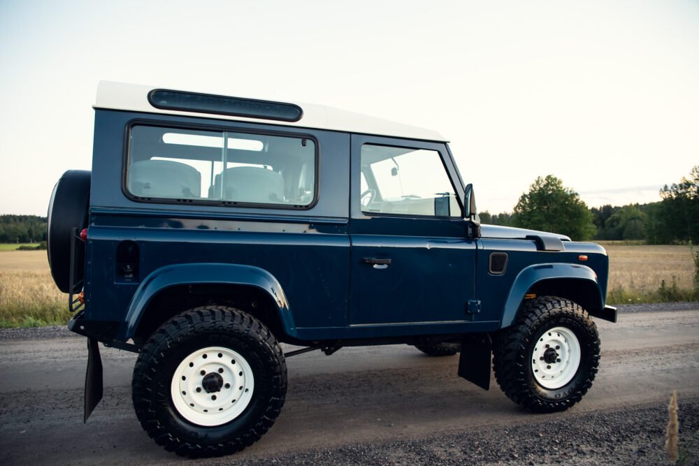 Blue off-road vehicle parked in countryside.