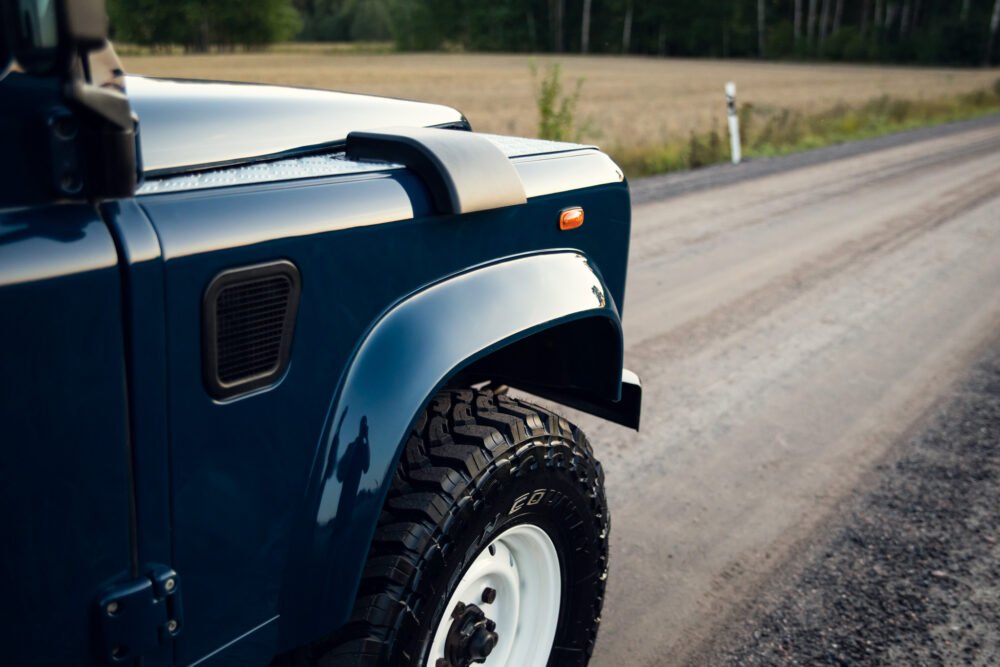 Blue off-road vehicle on a country road.