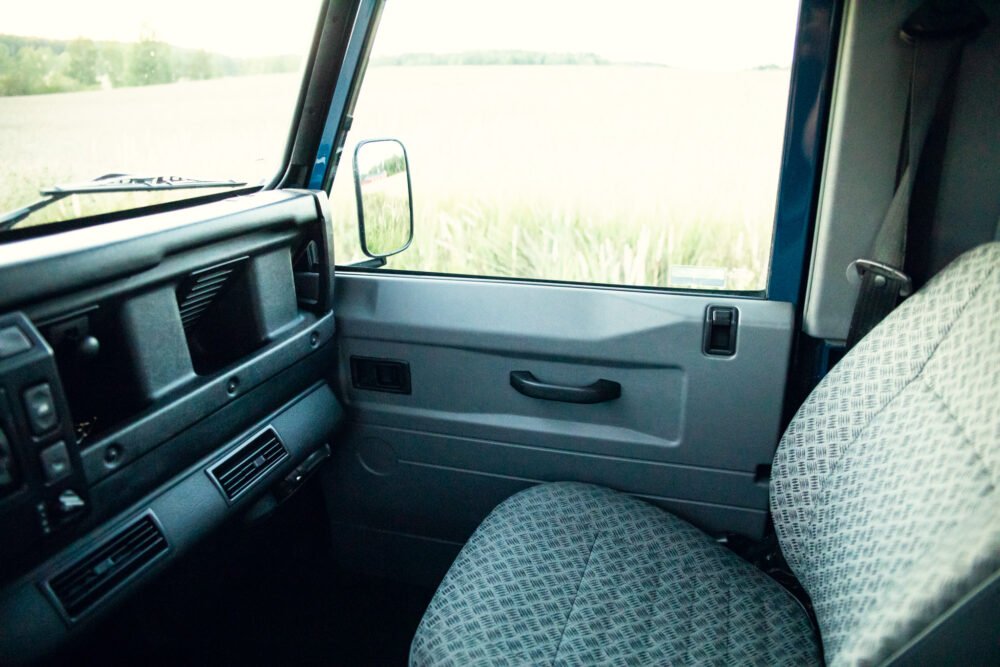 Interior view of old car with view on open door.