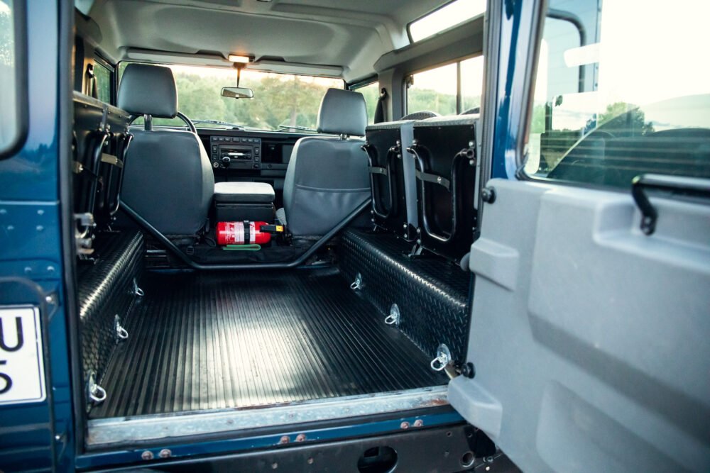 Interior view of empty SUV with open doors.