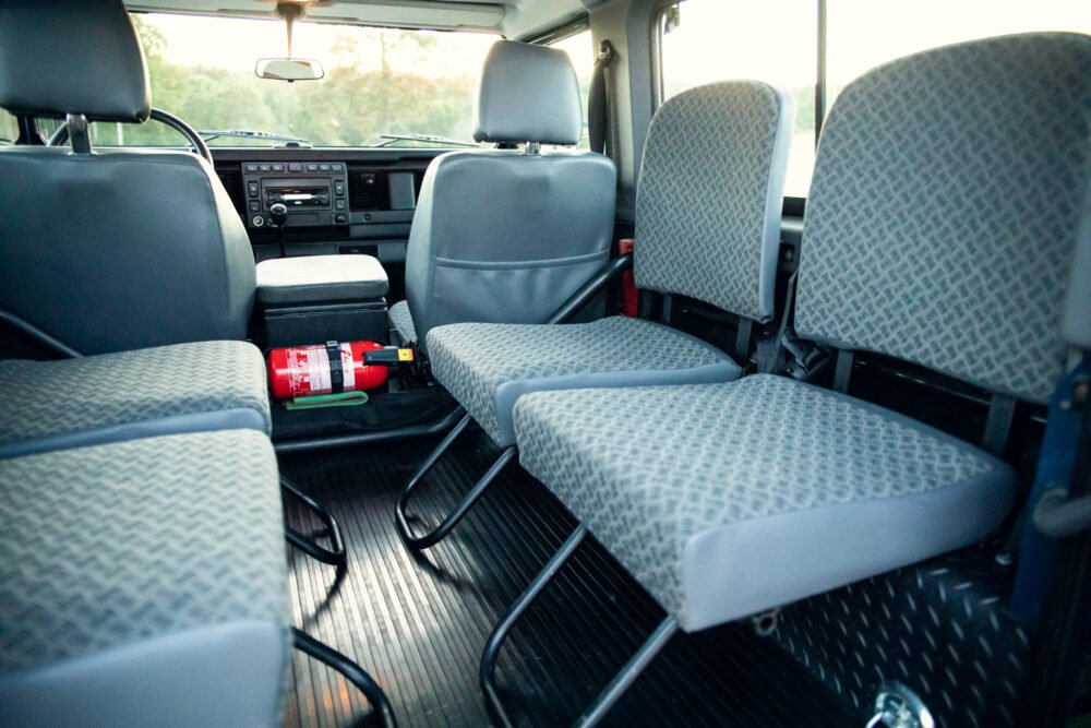 Interior of a modern, clean van with seats and dashboard.