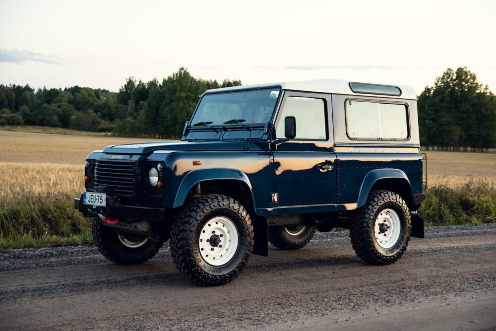 Blue off-road vehicle in countryside setting.