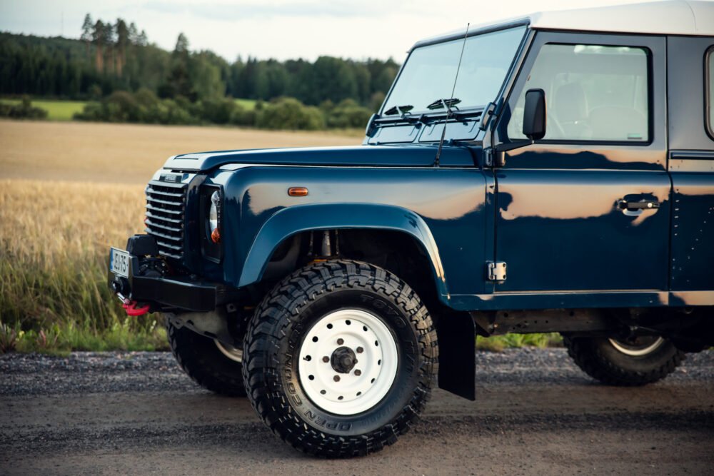 Blue off-road vehicle in rural setting.