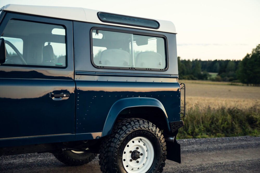 Blue off-road vehicle in countryside setting.