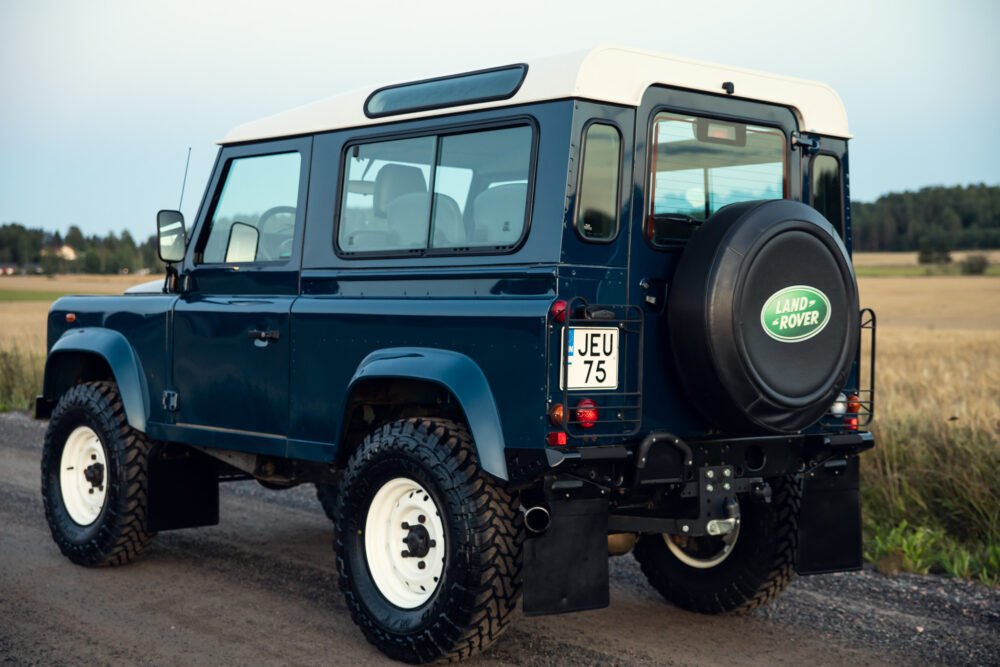 Blue Land Rover Defender parked outdoors.