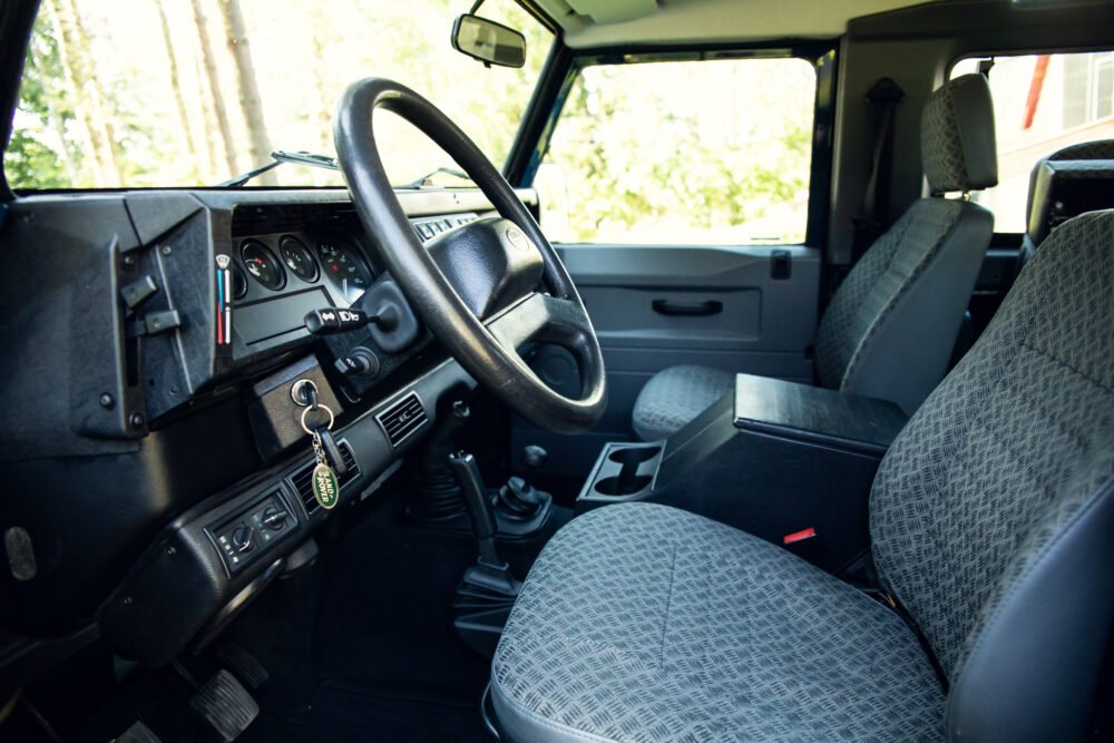 Interior of vintage SUV with patterned seats and dashboard.