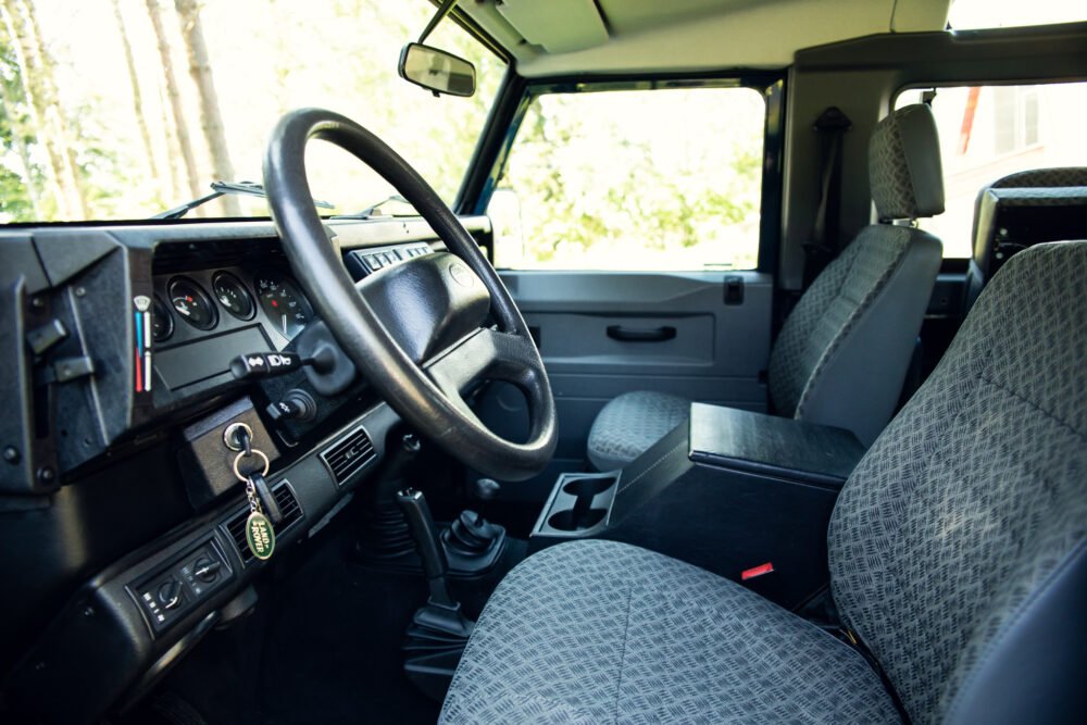 Interior view of vintage vehicle's dashboard and seats.