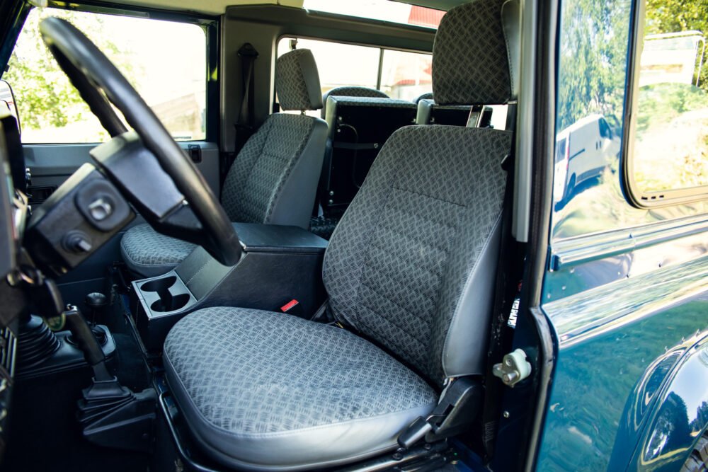 Interior view of a vintage vehicle with patterned seats.