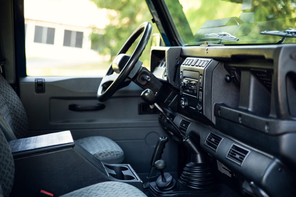 Interior view of a modern vehicle dashboard and steering wheel.