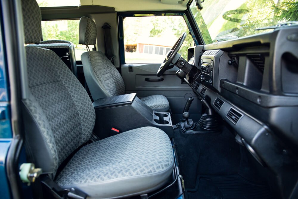 Interior view of vintage SUV with patterned seats.