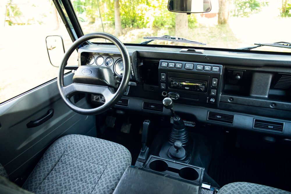 Interior view of a vintage vehicle with manual transmission.