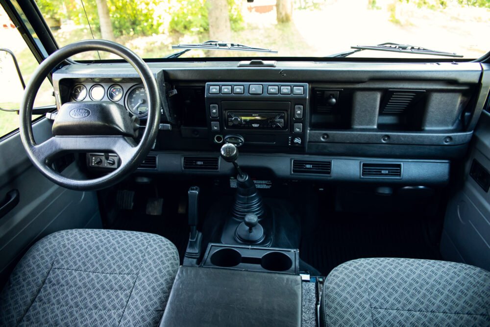 Interior view of vintage Land Rover with manual transmission.