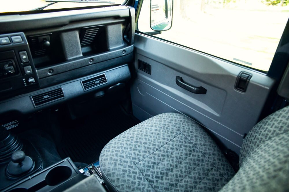 Interior view of vintage vehicle with patterned seats.