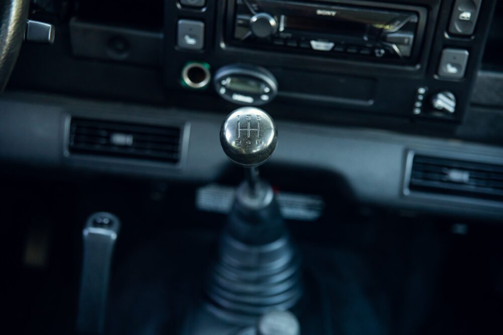 Close-up of manual transmission gear shift in car.